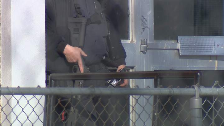 Police on guard at St. John’s High School in Winnipeg on Tuesday, October 21, 2014