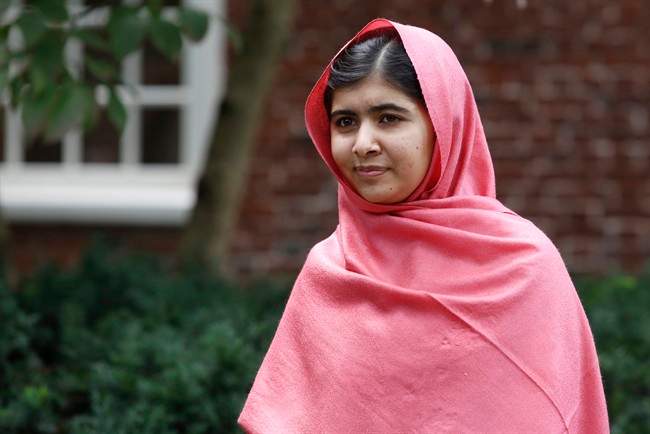 FILE - In this file photo taken Friday, Sept. 27, 2013, Malala Yousafzai listens as Harvard President Drew Gilpin Faust introduces her to reporters at Harvard University in Cambridge, Mass.