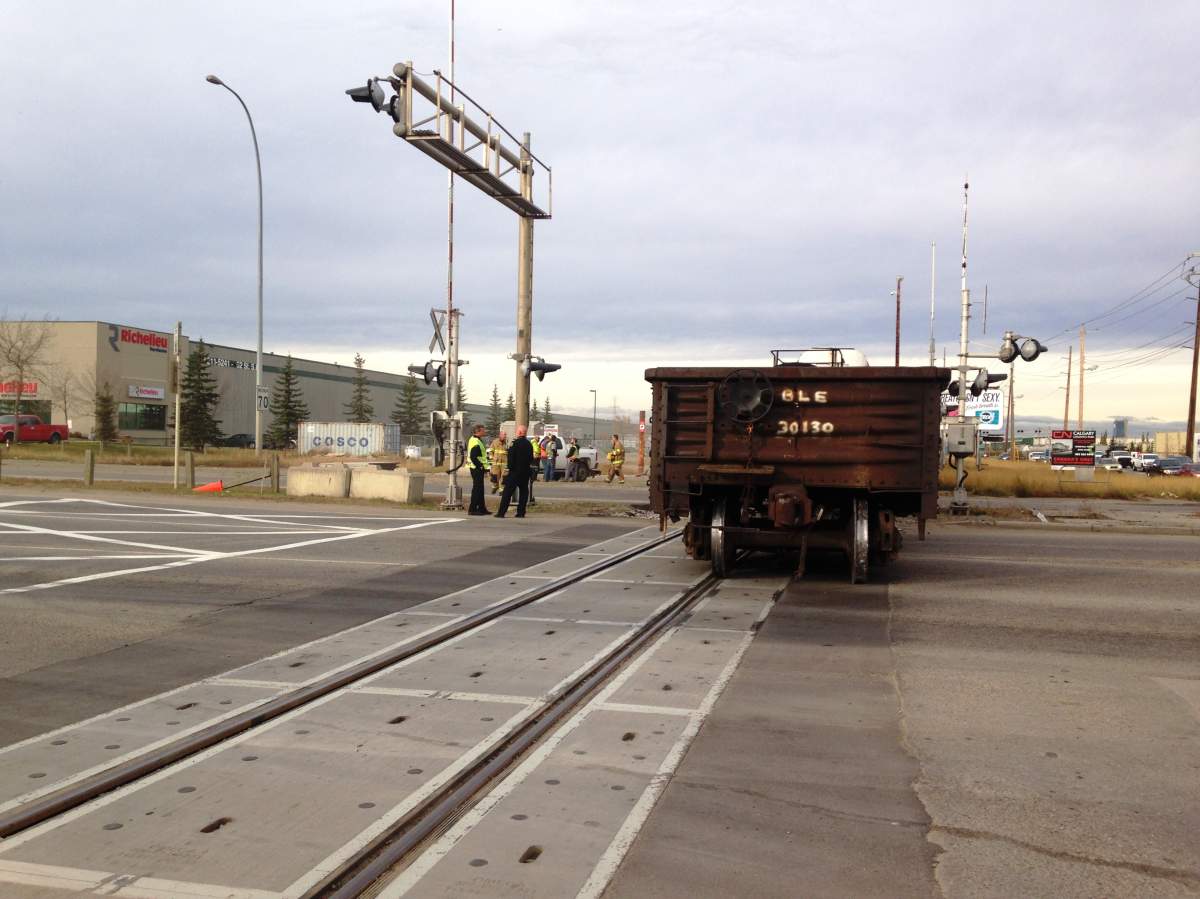 Emergency crews respond to a train derailment in the intersection of 50th Avenue and 52nd Street S.E. on Tuesday, October 21, 2014.