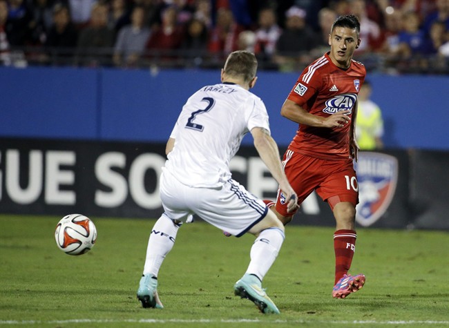 FC Dallas midfielder Mauro Diaz (10) makes a pass to Tesho Akindele past Vancouver defender Jordan Harvey (2) in the first half of an MLS playoff soccer match, Wednesday, Oct. 29, 2014, in Frisco, Texas. Akindele scored off the pass from Diaz. (AP Photo/Tony Gutierrez).