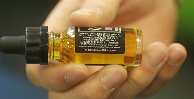 In this Aug. 14, 2014, photo, a child-proof refill bottle of liquid nicotine is shown at Salt Lake Vapors, in Salt Lake City.