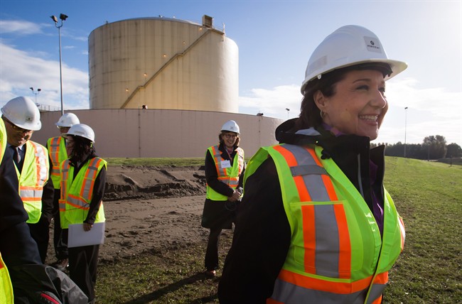 British Columbia Premier Christy Clark smiles during a tour before a groundbreaking event for FortisBC's Tilbury LNG facility expansion project in Delta, B.C..