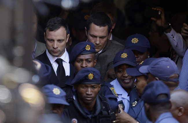 In this Friday, Sept. 12 file photo, escorted by police and security, Oscar Pistorius, left, leaves the high court in Pretoria, South Africa, after being found guilty of culpable homicide by judge Thokozile Masipa. Pistorius faces sentencing this week for killing girlfriend Reeva Steenkamp. 