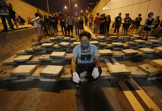 Demonstrators block the underpass with concrete slabs taken from drainage ditches at the main roads outside government headquarters in Hong Kong's Admiralty, Wednesday, Oct. 15, 2014.
