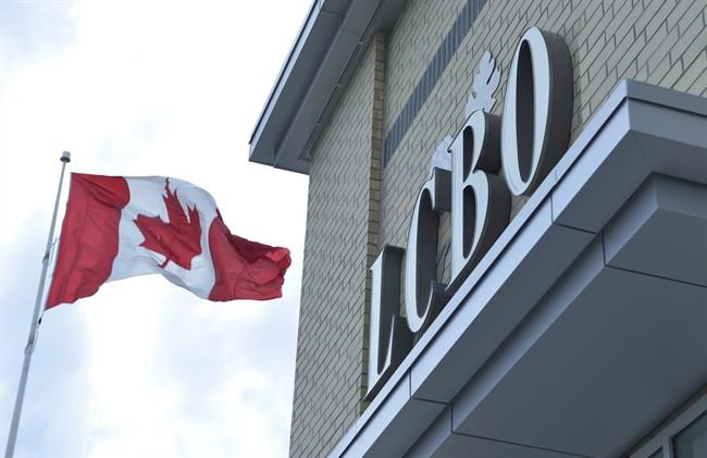 A Canadian flag flies near a LCBO store in Bowmanville, Ont. on Saturday July 20, 2013.