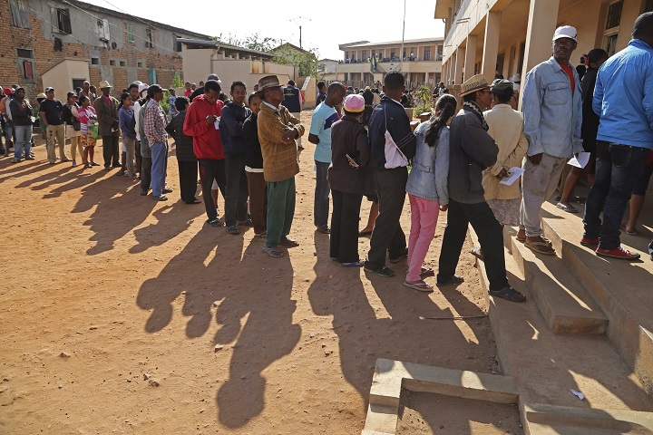 People stand in line to vote at a polling station during elections in Antananarivo, Madagascar, Friday, Oct. 25, 2013. 