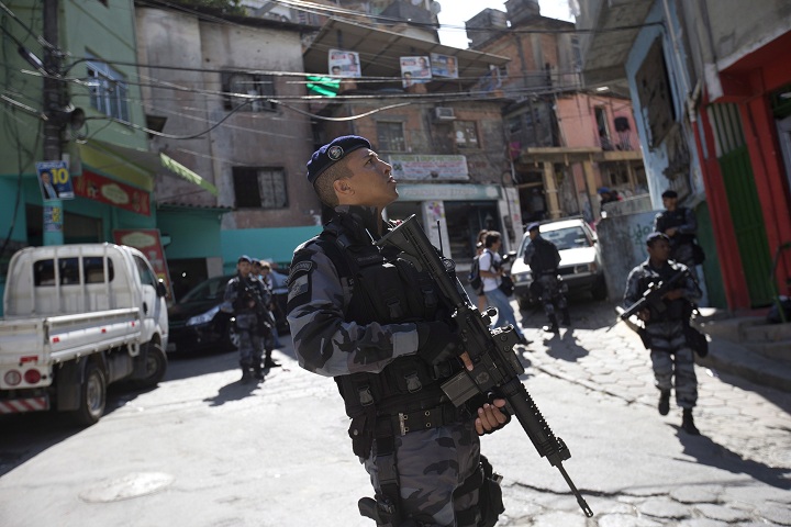 Police patrol in the Cantagalo slum ahead of a presidential run-off election in Rio de Janeiro, Brazil, Friday, Oct. 24, 2014.