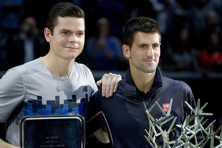 Milos Raonic of Canada, left, and Serbia's Novak Djokovic pose for photographers after Djokovic won the final of the ATP World Tour Masters tennis tournament at Bercy stadium in Paris, France,  Sunday Nov. 2, 2014.