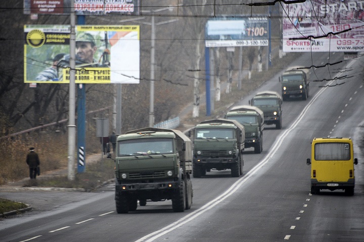 Unmarked military vehicles travel along a road outside the separatist rebel-held town Makiivka, 25 kilometres from Donetsk, eastern Ukraine on Saturday, Nov. 8, 2014.