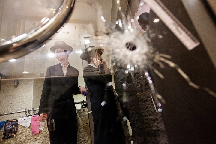 A bullet hole  in a glass door of a synagogue that was the scene of a terror attack in Jerusalem.