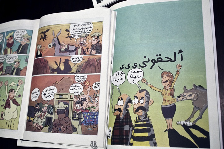 This Wednesday, Nov. 12, 2014 photo shows works by comic book artist Hagrassy, from Shakmagia magazine, at a coffee shop in Cairo. Cartoons and political satire go back more than 100 years in Egypt, and are a staple in newspapers that have often lampooned social mores and officials in public office. But a new generation of young comic artists is finding alternative space to express what is often a hard sell in mainstream media. 