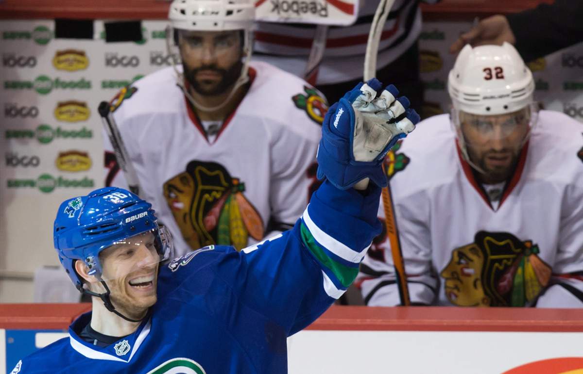 Vancouver Canucks' Jannik Hansen, of Denmark, celebrates after scoring his third goal. THE CANADIAN PRESS/Darryl Dyck.