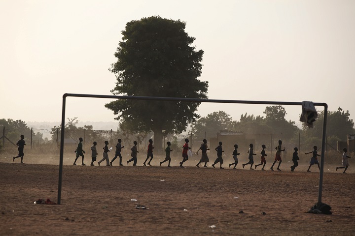 Children who fled their homes following an attack by Islamist militants run around a soccer ground at a camp in Yola, Nigeria, Friday Nov. 28, 2014.  
