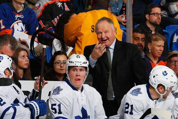 Randy Carlyle of the Toronto Maple Leafs looks on from the bench against the New York Islanders at Nassau Veterans Memorial Coliseum on October 21, 2014 in Uniondale, New York.