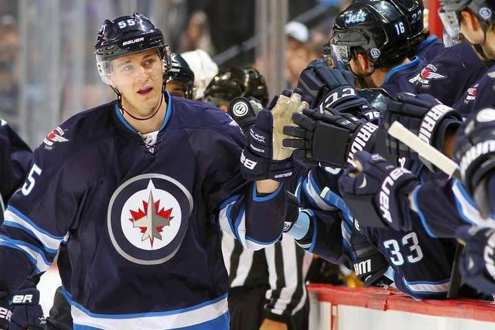 Mark Scheifele of the Winnipeg Jets celebrates his first-period goal against the Nashville Predators with teammates at the bench Tuesday at the MTS Centre in Winnipeg.