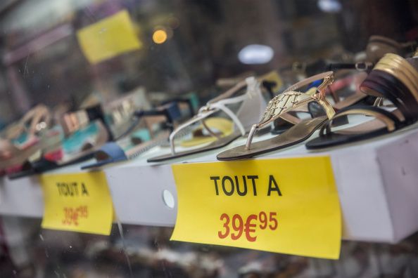 Euro price signs sit beneath a display of women's sandals in a footwear store in Toulouse, France, on Tuesday, Aug. 12, 2014.