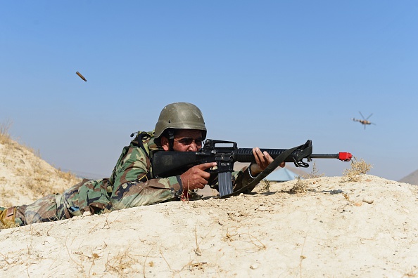 An Afghan National Army (ANA) soldier fires his weapon during a combat training exercise at the Afghan National Military training center (KMTC) in Kabul on October 22, 2014. Afghan casualties have rocketed over the past two years, during which time NATO has handed over most combat duties to the nation's police and army. 