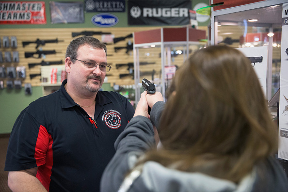 Steven King (L) helps Sara Happel shop for a handgun to have for home defense at Metro Shooting Supplies on November 12, 2014 in Bridgeton, Missouri.