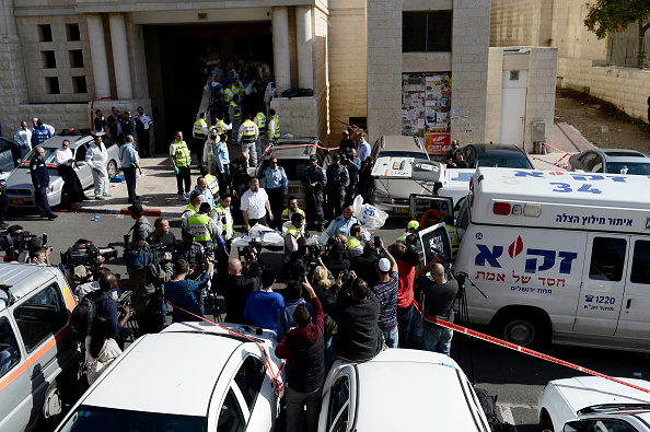 Members of the Israeli emergency service carry the bodies of synagogue attack victims in Jerusalem on November 18, 2014. Four Israelis were killed and seven others injured in an attack by two Palestinians on a Jewish synagogue in West Jerusalem, with the two attackers gunned down by Israeli police in the immediate wake of the attack. 