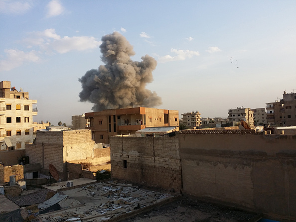 Smoke rises after air strikes by Syrian army  warplanes on the ISIL-held northern city of Raqqa, Syria on November 25, 2014. 