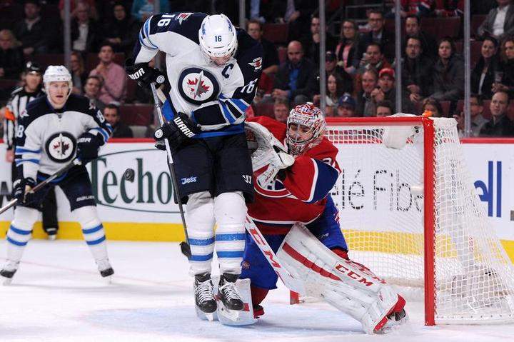 Andrew Ladd of the Winnipeg Jets attempts to deflect the puck in front of Carey Price #31 of the Montreal Canadiens when the teams met in November. The Montreal Canadiens' chances of making the playoffs are best among Canadian teams while the Winnipeg Jets are doing well too, according to Sports Club Stats.