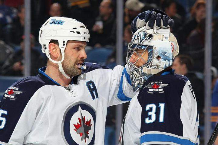 Mark Stuart, left, with Ondrej Pavelec in November, is out of the Winnipeg Jets' lineup until February.