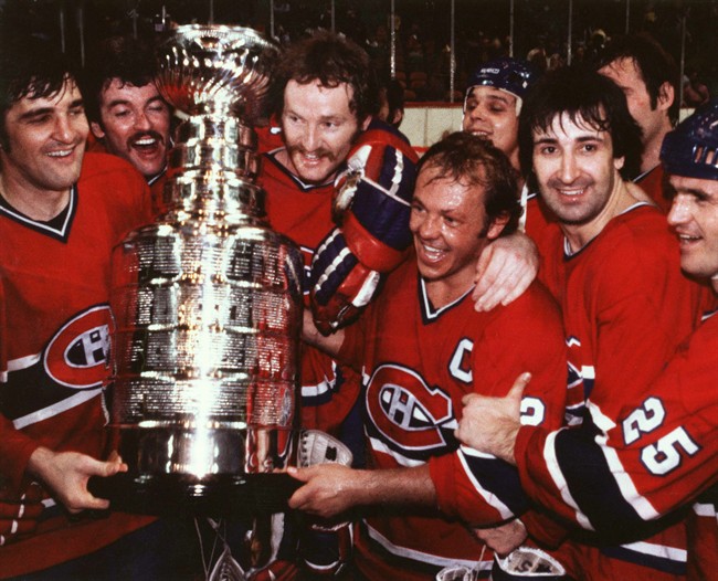 Members of the Montreal Canadiens gather around the Stanley Cup after defeating the Boston Bruins, May 25, 1978 at the Boston Garden. Left to right are: Serge Savard, Yvon Lambert, Larry Robinson, Yvan Cournoyer, Guy Lapointe and Jacques Lemaire. Partially hidden are Pierre Larouche and Ken Dryden.