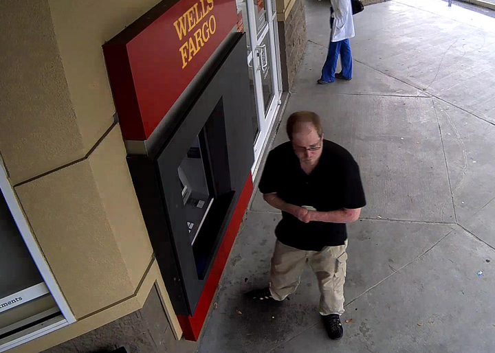 In an image from surveillance video provided by the Orange County, Fla.,Sheriffs Office, Sean Petrozzino, a 30-year-old quadruple amputee, is seen at a bank ATM on Nov. 4, 2014, the day his parents were shot.