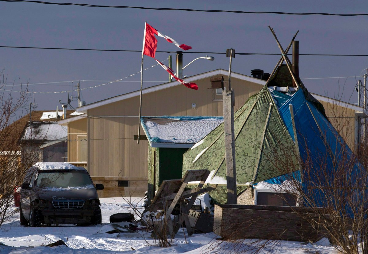 In this December 17, 2011 photo, a tattered Canadian flag flies over a teepee in Attawapiskat, Ont. THE CANADIAN PRESS/Frank Gunn.