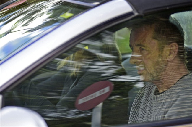Phil Rudd, the drummer for rock band AC/DC, leaves a court house in Tauranga, New Zealand, Thursday, Nov. 6, 2014, after being charged with attempting to procure murder. The 60-year-old has also been charged with threatening to kill and possession of methamphetamine and marijuana.