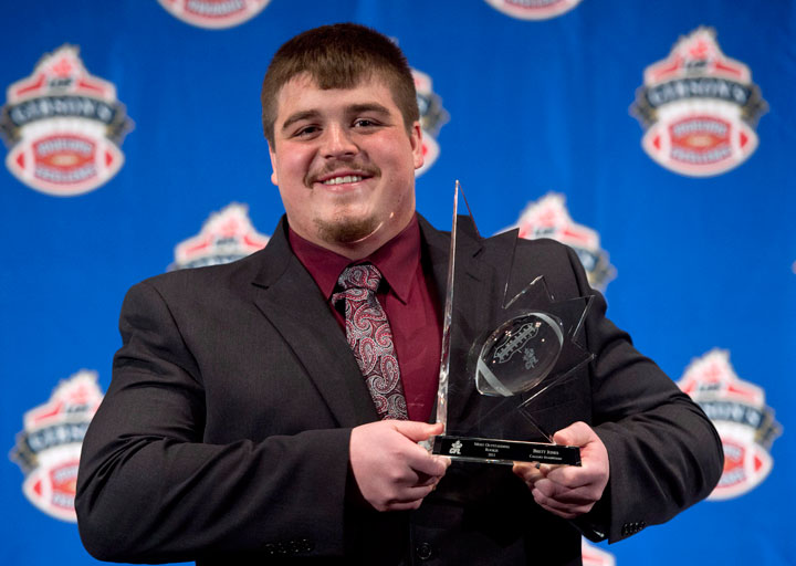 Brett Jones, of the Calgary Stampeders, holds his trophy for the rookie of the year at the CFL Players Awards Thursday November 21, 2013 in Regina.