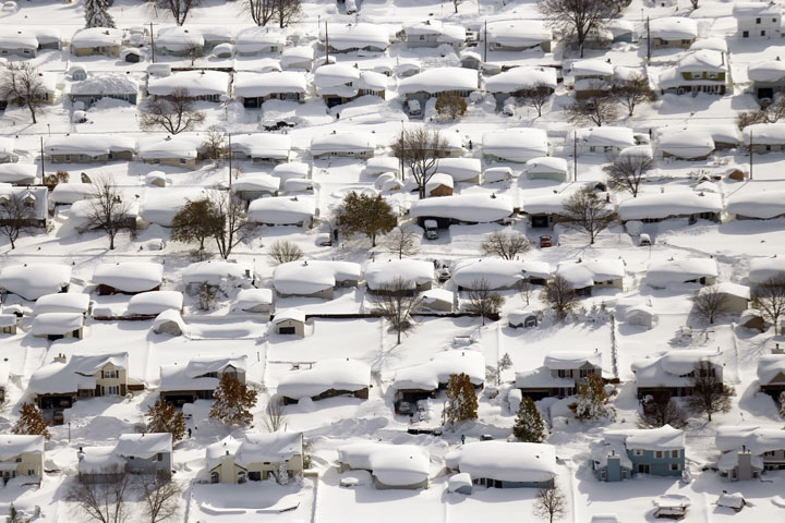Homes are covered in snow in West Seneca, N.Y.,Wednesday, Nov. 19, 2014. 