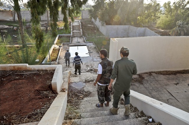 Libyan military soldiers inspect damage after heavy clashes in Benghazi in November, 2014.