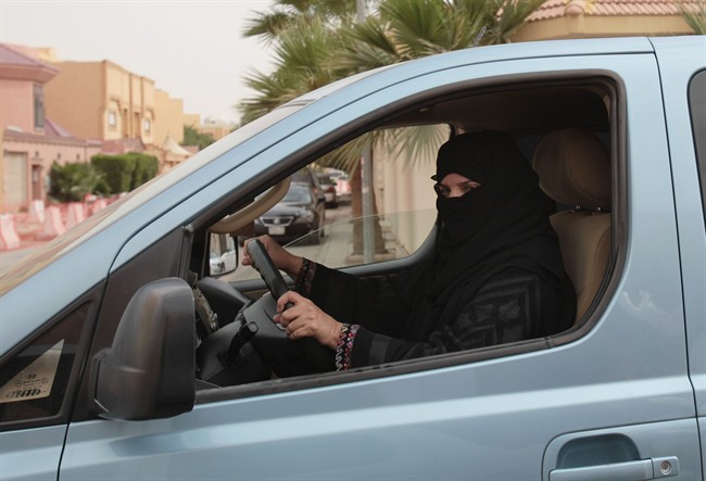 FILE - In this file photo taken Saturday, March 29, 2014, Aziza Yousef drives a car in Riyadh, Saudi Arabia, as part of a campaign to defy Saudi Arabia's ban on women driving. A Saudi official said Friday, Nov. 7, that the kingdom's advisory council has recommended to the government for the first time the partial lifting of the ban on women driving, but with conditions: Only women over 30, only during the day, and no makeup allowed while driving. (AP Photo/Hasan Jamali, File).