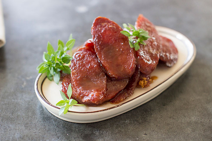 This Nov. 10, 2014 photo shows candied kielbasa bites in Concord, N.H. It's easy to elevate a holiday party spread beyond a bowl of mixed nuts, grapes and a wedge or two of cheese, by using a few more creative offerings.