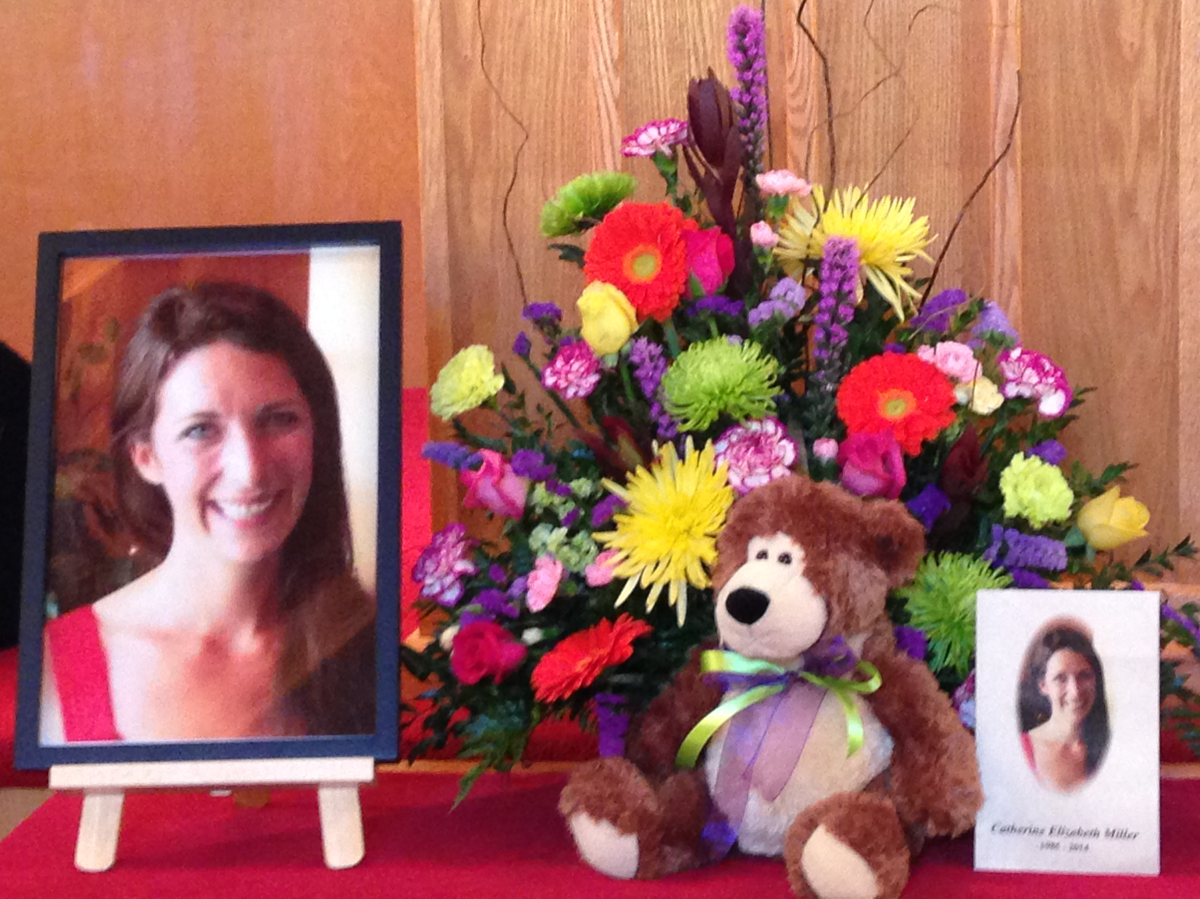 Pictures and flowers sit at the front of the church where the memorial service for Catie Miller was held on Nov. 29, 2014.