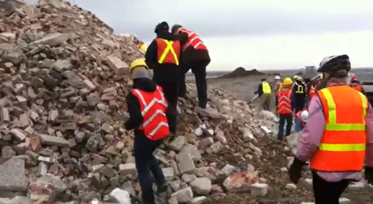 The Save Our Connaught group collected bricks from debris of the demolished Ecole Connaught Community School at the city's landfill on Sunday.