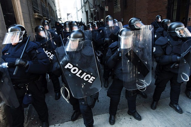 Riots police get ready to deploy as activists and protesters march along the streets of downtown Toronto during the G8/G20 Summits on Friday, June 25, 2010.