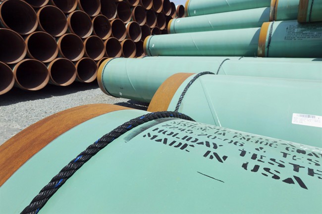 This May 24, 2012 file photo shows some of about 500 miles worth of coated steel pipe manufactured by Welspun Pipes, Inc., originally for the Keystone oil pipeline, stored in Little Rock, Ark. There are new threats of lawsuits against Canadian oil pipeline projects in the United States.