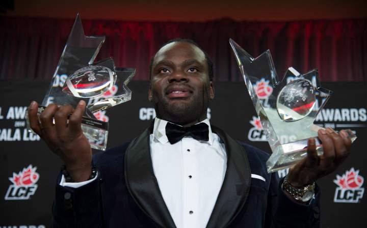 BC Lions linebacker Solomon Elimimian holds his awards for Most Outstanding Player and Most Outstanding Defensive Player.