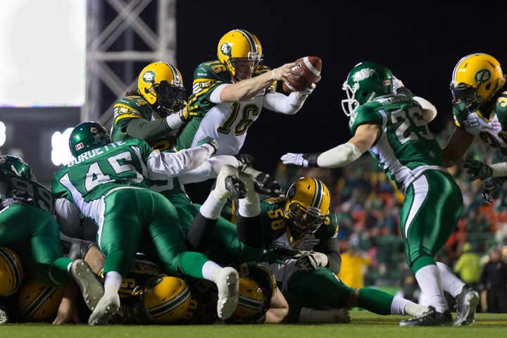 Matt Nichols #16 of the Edmonton Eskimos stretches for a touchdown in a game between the Edmonton Eskimos and Saskatchewan Roughriders in week 20 of the 2014 CFL season at Mosaic Stadium on November 08, 2014 in Regina.
