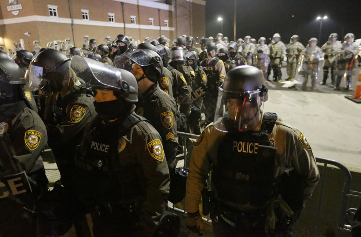 Police line up in front of the Ferguson Police Department in November. The Missouri governor has ended the state of emergency for the area.