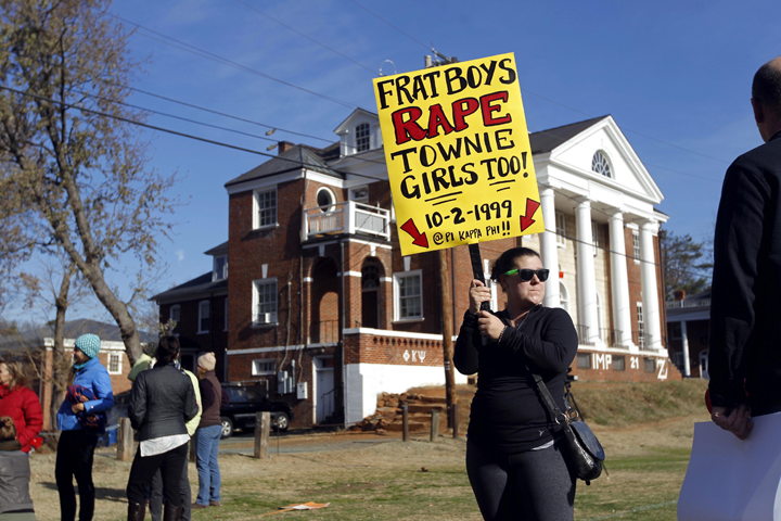 Shannon Cruse Ranson, from Norfolk, holds a sign detailing her own experience with rape during a protest at the Phi Kappa Psi fraternity house at the University of Virginia in Charlottesville on Saturday, Nov. 22, 2014.