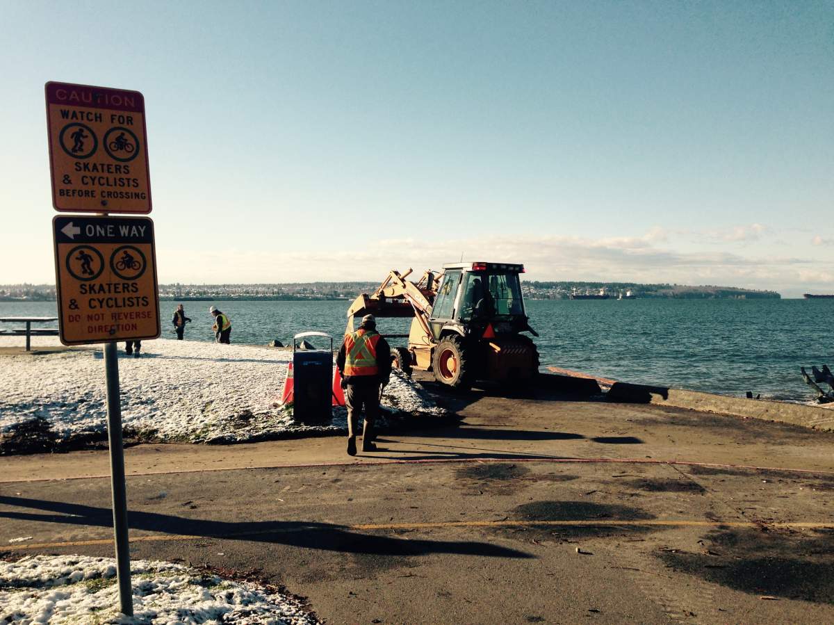 Crews clear debris from Seawall.
