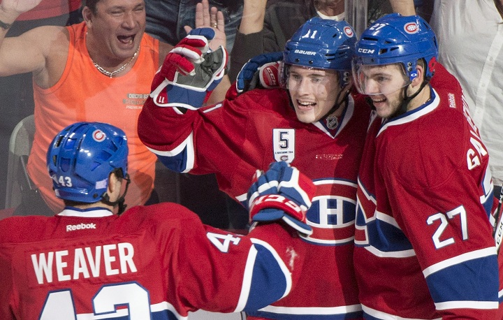 Montreal Canadiens' Brendan Gallagher (11) celebrates with teammates Alex Galchenyuk (27) and Mike Weaver after scoring against the Minnesota Wild during second period NHL hockey action in Montreal, Saturday, November 8, 2014.