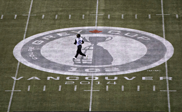 Hamilton Tiger-Cats' wide receiver Brandon Banks runs across a Grey Cup logo painted on the field at BC Place.