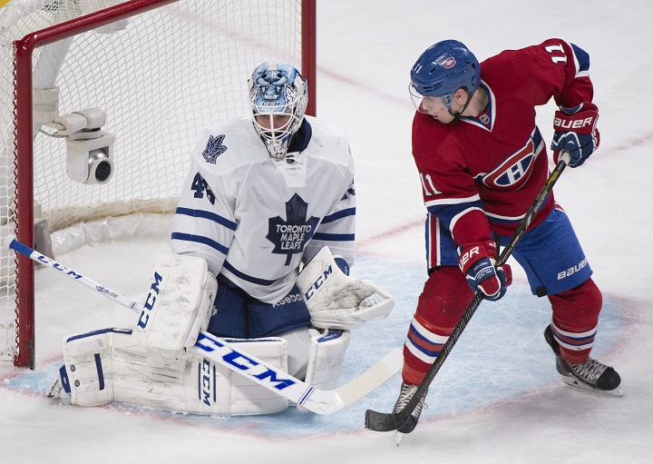 Montreal Canadiens' Brendan Gallagher, right, moves in on Toronto Maple Leafs' goaltender Jonathan Bernier.