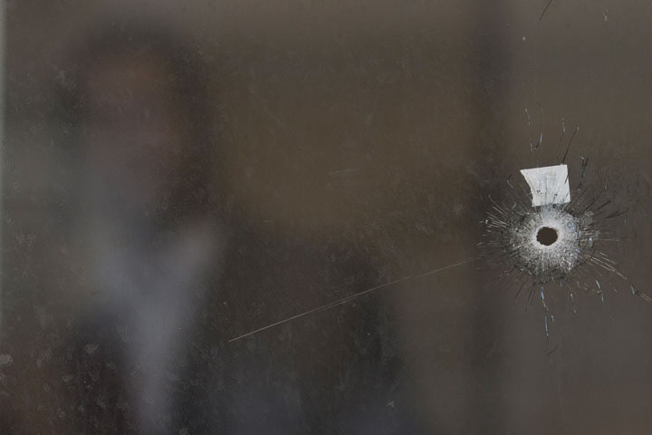 A bullet hole and forensic evidence are seen inside the Synagogue at the site of an attack in Jerusalem, Tuesday, Nov. 18, 2014. (AP Photo/Ariel Schalit)