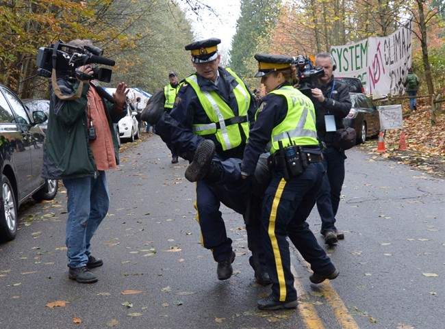 RCMP officers remove a protestor at an anti-pipeline demonstration in Burnaby, B.C., on Thursday, Nov. 20, 2014.