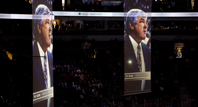 Banners showing former Vancouver Canucks player, coach and general manager Pat Quinn are pictured during a tribute to him prior to the first period of NHL action between the Canucks and the New Jersey Devils in Vancouver, B.C., on Tuesday, Nov. 25, 2014. Quinn died Sunday night at the age of 71 after a long illness. THE CANADIAN PRESS/Jonathan Hayward.
